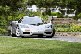 Sleek Luxury Car on Scenic Driveway PNG