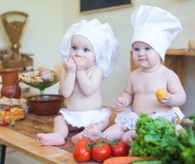 2 cook costume Baby and food Stock Photo