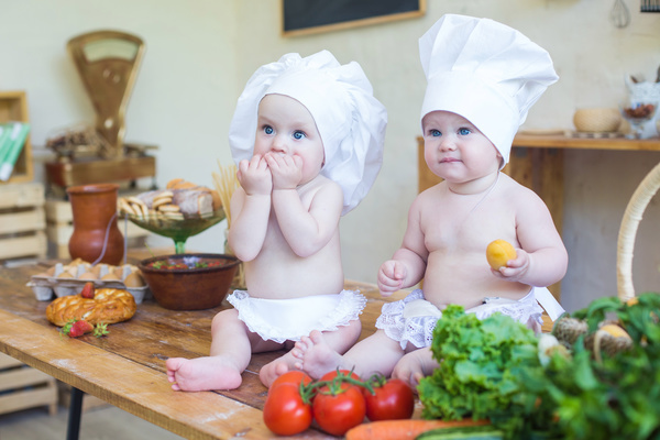 2 cook costume Baby and food Stock Photo