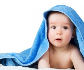A baby looking around in a blanket Stock Photo