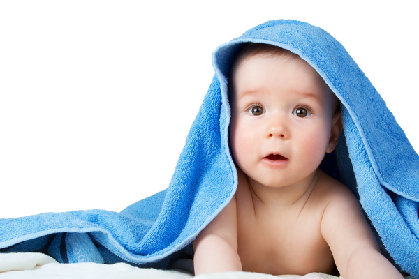 A baby looking around in a blanket Stock Photo