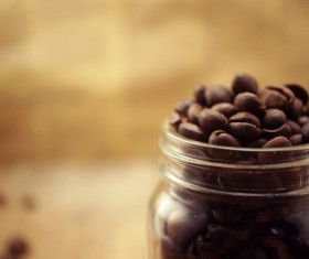 A blurred photograph of a glass of coffee beans