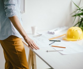 A drawing engineer standing in front of a table