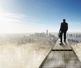 A man standing on a height overlooking the city