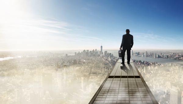 A man standing on a height overlooking the city