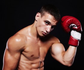 A young boxer who slaps his head with boxing gloves HD picture