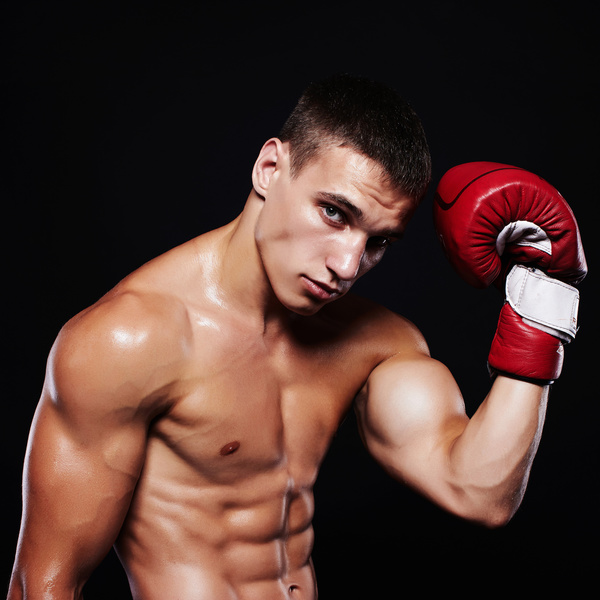 A young boxer who slaps his head with boxing gloves HD picture