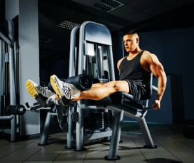 A young man doing leg exercise on equipment
