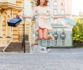 After shopping Excited woman jumping Stock Photo 01