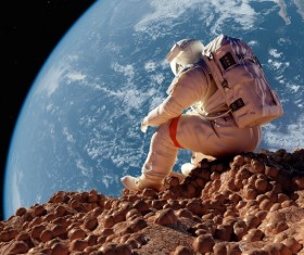Astronauts sitting on the moon watching the earth