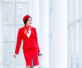 Attracting stewardess with a suitcase on white background HD picture