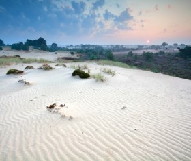 Barren desert and distant background of the sun