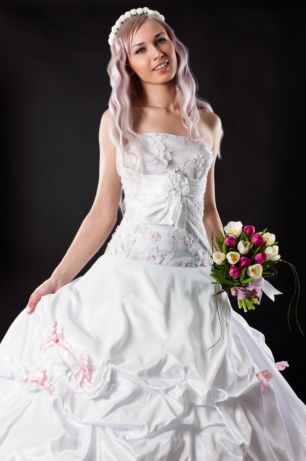 Beautiful bride wearing wedding dress with black background