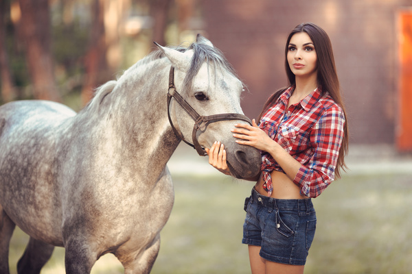 Beautiful girl with gray horse