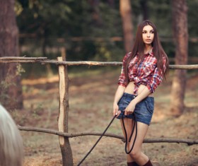 Beautiful girl with horse and forest background