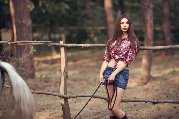 Beautiful girl with horse and forest background