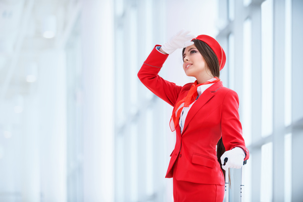 Beautiful young stewardess with a white background HD picture