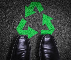 Black background shoes and green recycling logo Stock Photo