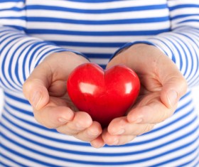 Holding a red heart-shaped Stock Photo