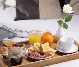 Breakfast and computer newspapers on the bed