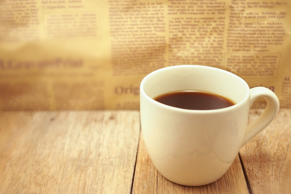 Coffee and newspaper wiht blurs background