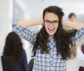 Cover your ears open mouth of a young woman