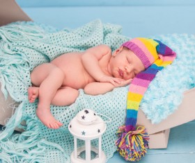 Cute newborns and lanterns in bed Stock Photo
