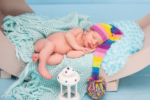 Cute newborns and lanterns in bed Stock Photo