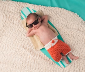 Dress up the cool baby lying on the water board