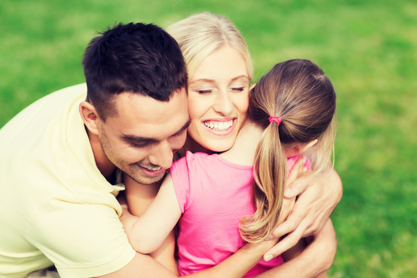 Embracing wife with children and green background
