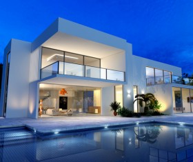 External view of a contemporary house with pool at dusk Stock Photo