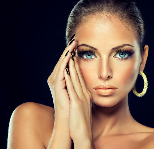 Fashion models beautiful jewelry black eyelashes golden nails