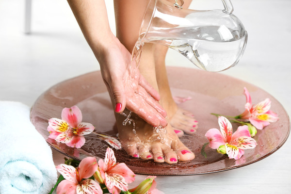 Female hands and feet with petal