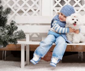 Girl sitting on a bench with white puppy Stock Photo