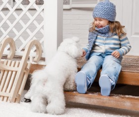 Girl sitting on the promenade and white puppy Stock Photo