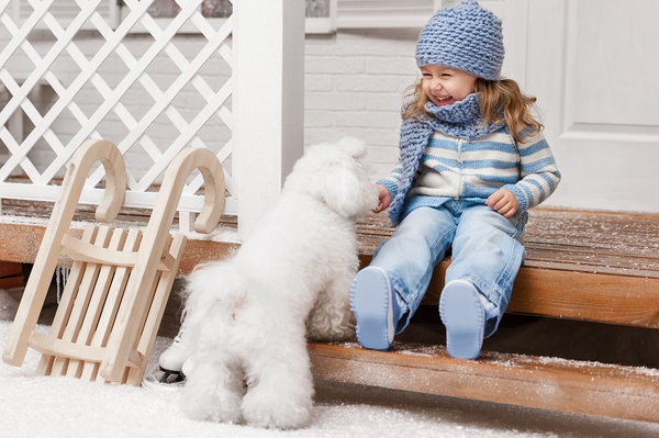 Girl sitting on the promenade and white puppy Stock Photo