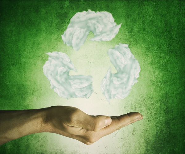 Green background hand holding white clouds shape recycling sign