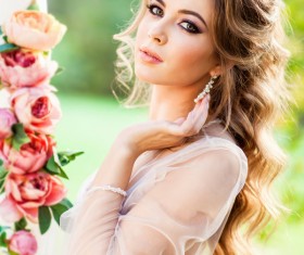 HD picture Young beautiful woman stroking earrings