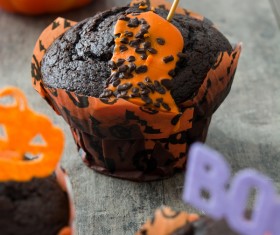 Halloween pumpkin little monster dessert on wood background