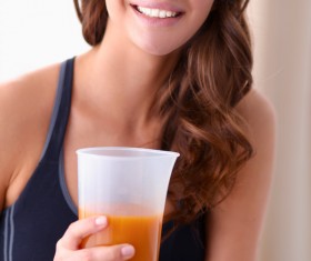 Hand holding vegetable juice Healthy young woman