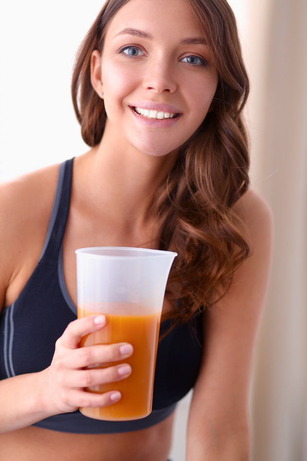 Hand holding vegetable juice Healthy young woman