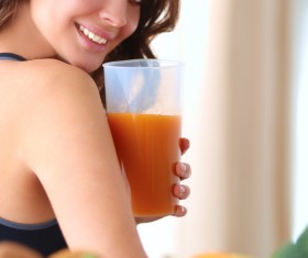 Hand holding vegetable juice Smiling young beautiful woman turning