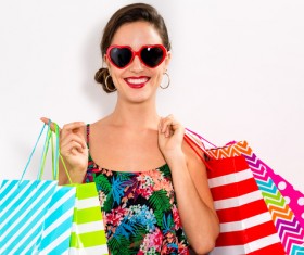 Happy woman holding shopping bags on white background