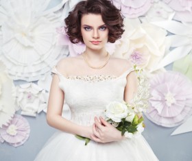 Holding flowers Happy woman wearing wedding dress with fake background