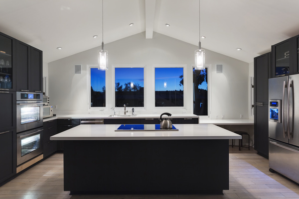 Interior Of Kitchen With High Vaulted Ceiling Pendant Lights White Kitchen Cabinetry And Steel Appliances Free Download