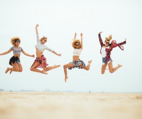 Jumping young beautiful girl on the beach HD picture