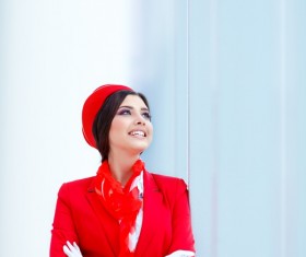 Leaning against the glass wall looking at the sky smiling flight attendants