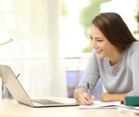Looking at laptop Pretty young woman studying woman