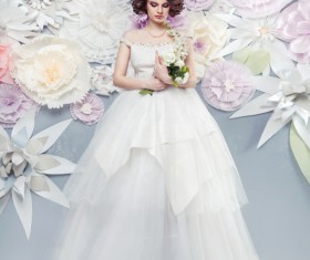 Happy woman wearing a wedding dress with fake background