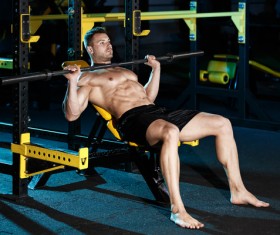 Man doing flat - out exercise at the gym HD picture